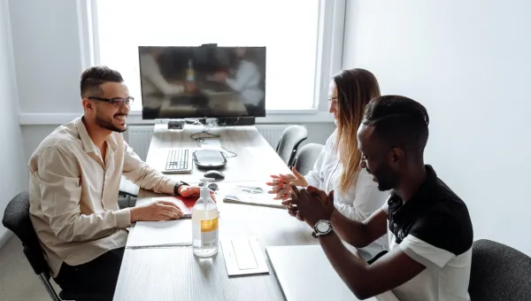 three people in discussion in business meeting room 