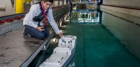 Ship science student Umberto Varbaro tests a model ship in the towing tank
