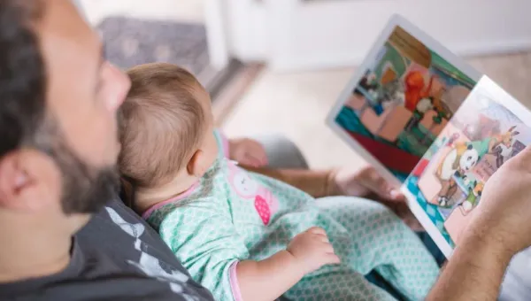 Father reading a book to his baby