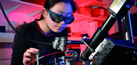 Person in laboratory using laser equipment