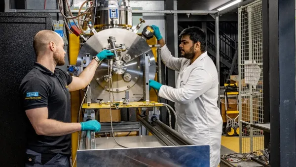 Researchers working with testing equipment
