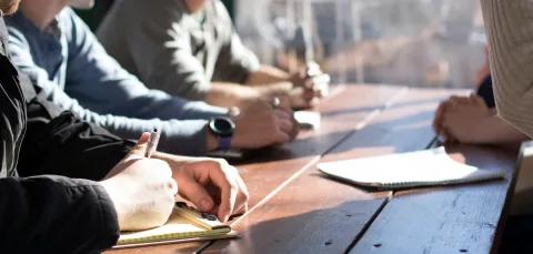 People round a table in a meeting