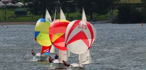 3 sailing boats with spinnakers in a line