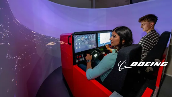 Two students use the Boeing flight simulator