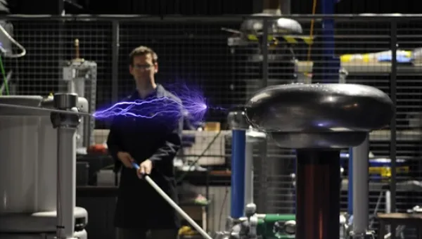 A man doing an experiment on electricity power in a lab