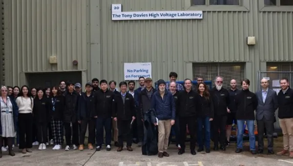 Group of researchers and students in front of the Tony Davies High Voltage laboratory