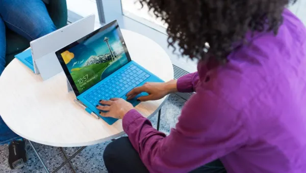 One woman working on her laptop on a small table