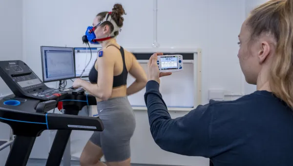 A researcher is measuring core temperature and metabolic analysis in the Climate Lab