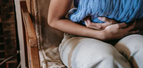 A woman with her hands on her stomach