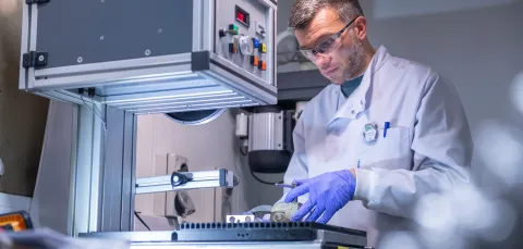 Scientist carrying out experiment using the facilities equipment