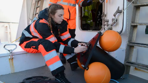 Researcher on boat preparing hydrophone for acoustic surveys of marine mammals in the Antartic