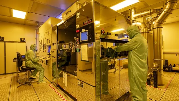 2 men working within Nikon S240 DUV Scanner equipment