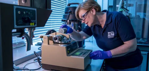 Consultant using a taber abraser at nC2 Consulting