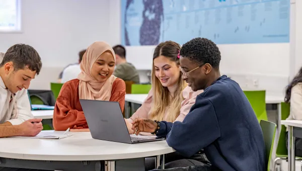 Students gathered round a laptop