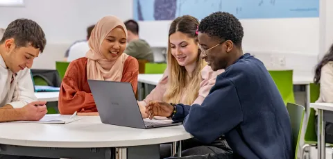 Students gathered round a laptop