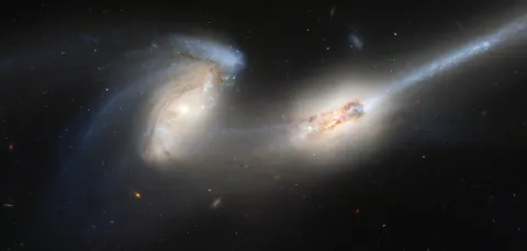 A satellite image of two galaxies colliding with each other.