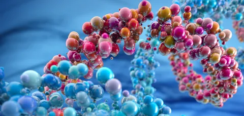 Colourful abstract representation of a molecular structure with glossy spheres in various sizes and colours against a blue background.