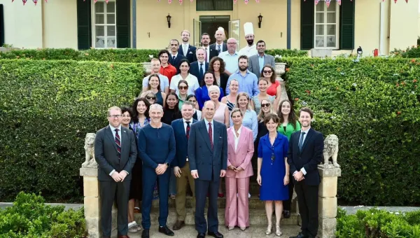 Their Royal Highnesses the Duke and Duchess of Edinburgh, Jacob Brooks and the embassy staff standing on the steps outside the British embassy in Malta.
