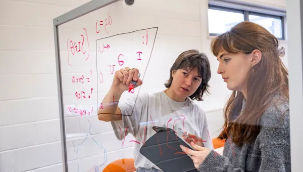Two students filling in a vowel space with symbols from the International Phonetic Alphabet’