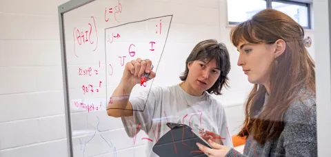 Two students filling in a vowel space with symbols from the International Phonetic Alphabet’