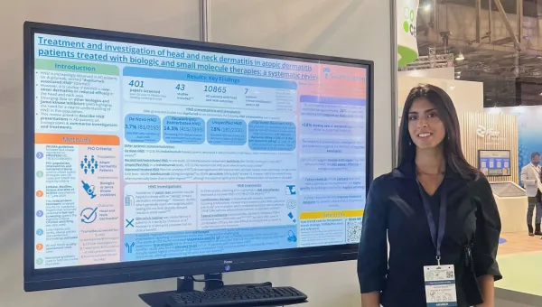 Hannah presenting her research in front of  a whiteboard