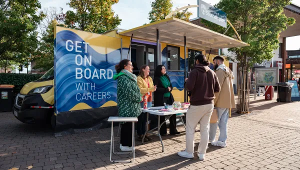 Careers staff speaking with students at a University of Southampton careers stand on campus.