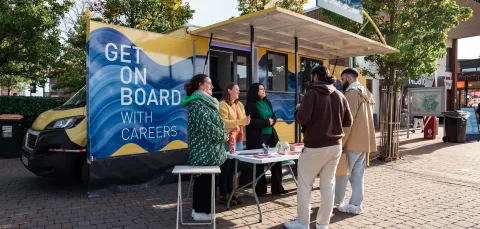 Careers staff speaking with students at a University of Southampton careers stand on campus.