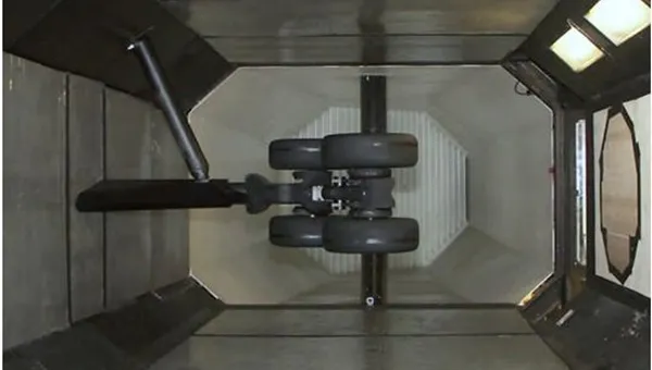 Overhead view of aircraft landing gear mounted inside a test chamber