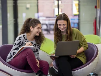 Students in conversation in the student union building.