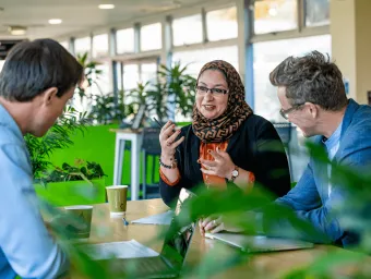 A member of staff having a discussion on campus.