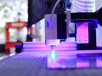 A pulsed fibre laser cutting through metal