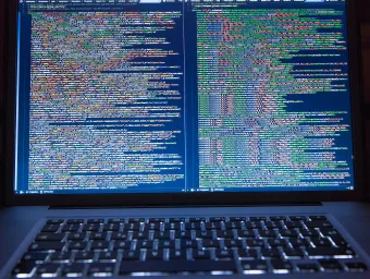 A computer screen, filled with code. We code to develop and deploy machine learning programs
