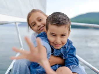 Close of two happy looking young children on a yacht