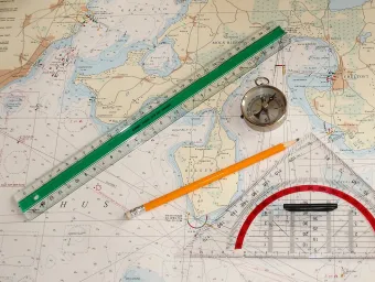 Nautical chart with a pencil, ruler and compass on it
