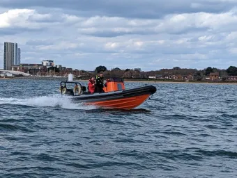 Powerboat with instructor and student out on the water