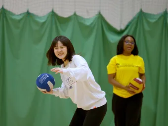 Women practising volleyball throws