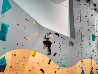 A climber climbing up Southampton University's indoor climbing wall