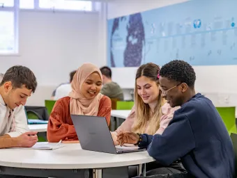 Students gathered round a laptop