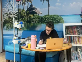 Gio keeping up with her studies while she receives treatment in the hospital.