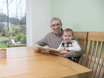 Mike and his grandson sitting in the light and airy dining room at the dining table.