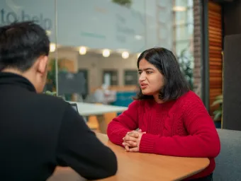 Careers adviser speaking with a student during a one-to-one discussion.