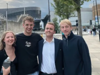 Daniel (second from the right) stands with arms around 3 friends he made on his course