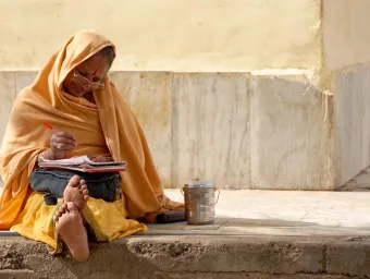 Woman sat on street working