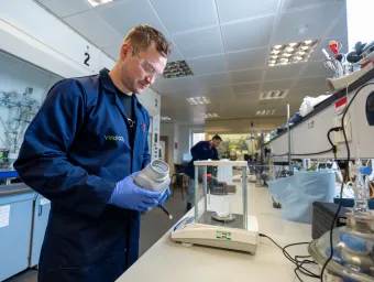 Dan Stewart weighing materials during laboratory research at Viridi.