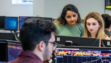 Business analytics degree students looking at Bloomberg screens