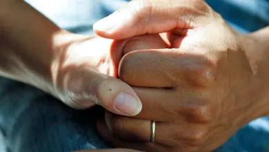 Unsplash image of a couple's clasped hands