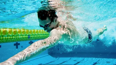 Man swimming under water in a swimming pool.