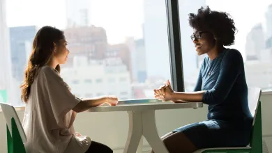 Two women talking at a table