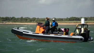 An instructor and student in a powerboat 