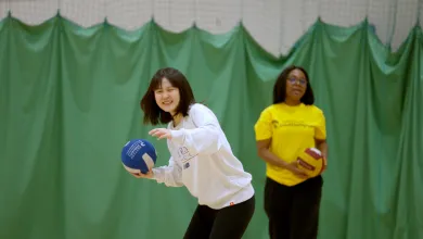 Women practising volleyball throws